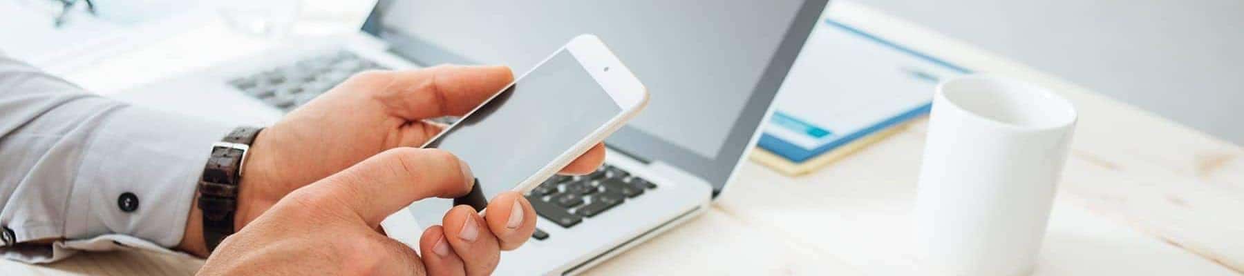 FINANCE Financing on smartphone and laptop on a desk copy