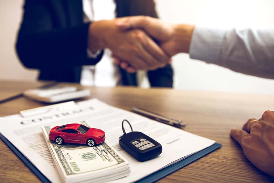 business handshake with car keys