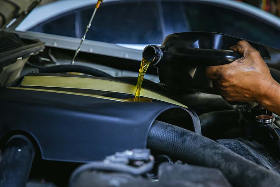 Car Mechanic Pouring Oil