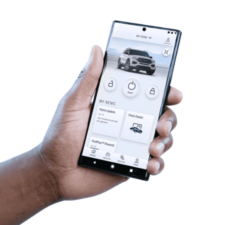 Hand holding a smartphone displaying the FordPass app