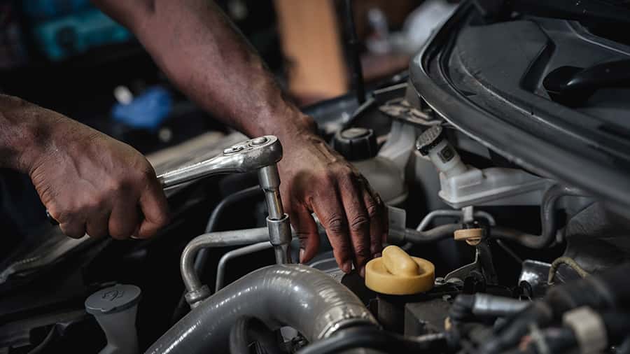 Car Mechanic Checking on Engine
