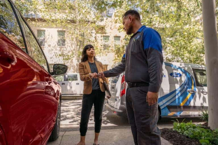 Ford service technician with a customer for a Ford recall.
