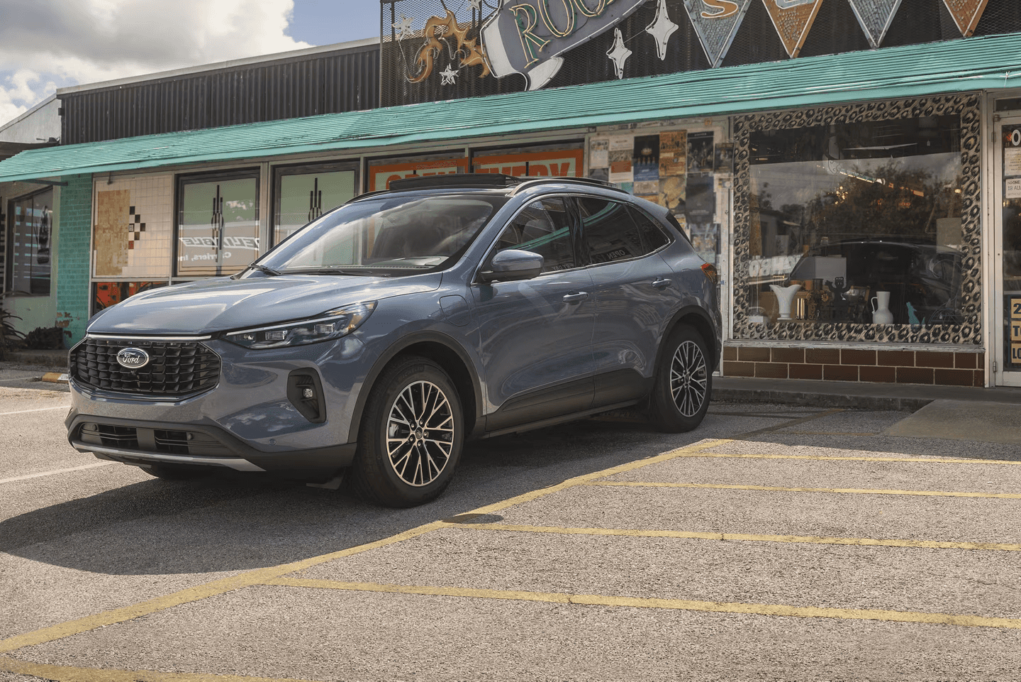 2025 Ford Escape parked outside a retro-themed storefront, showcasing its sleek design and eco-friendly appeal.