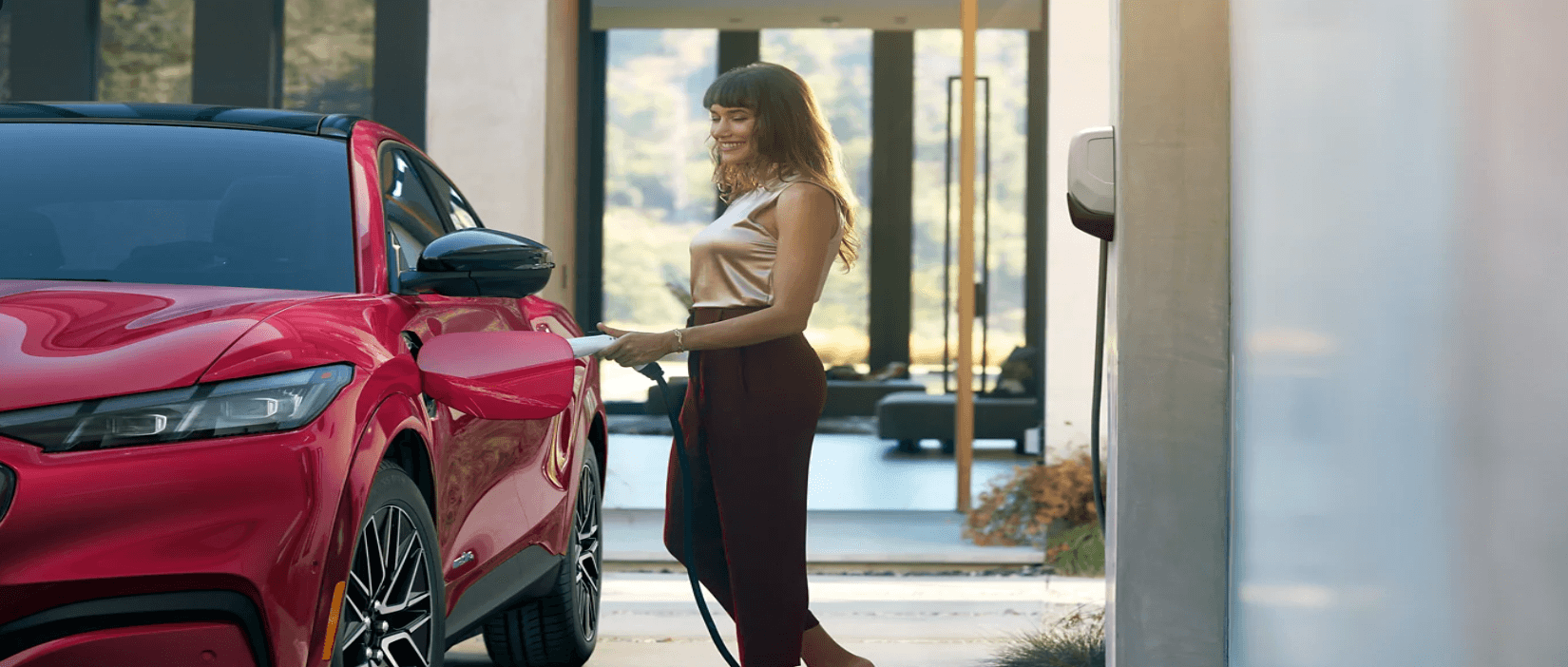 Women charging the 2025 Ford Mustang Mach-E in residence.