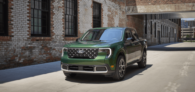 2025 Ford Maverick compact pickup in green parked by a brick building in Cookeville, TN.