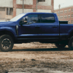 A blue Ford Super Duty Tremor parked at a construction site.