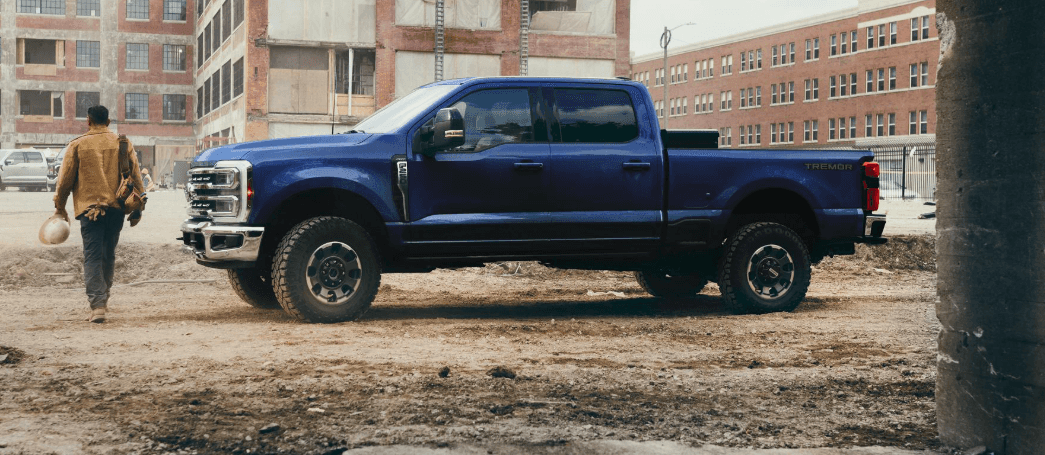 A blue Ford Super Duty Tremor parked at a construction site.