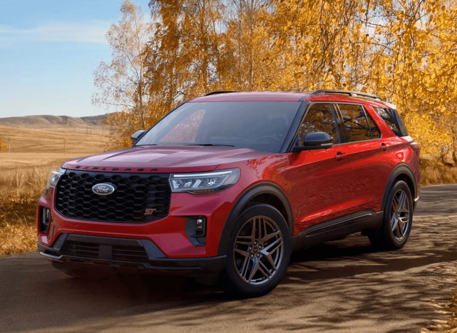 Red 2026 Ford Explorer driving on a scenic fall road for Ford of Cookeville.