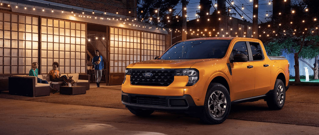 2026 Ford Maverick pickup parked at night under patio string lights