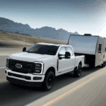 White 2026 Ford F-350 Super Duty towing a trailer on the highway