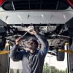 Ford technician services under a vehicle