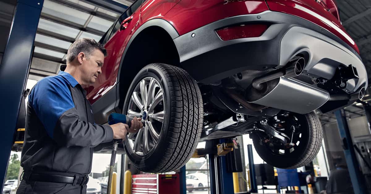 Ford service technician working on wheels