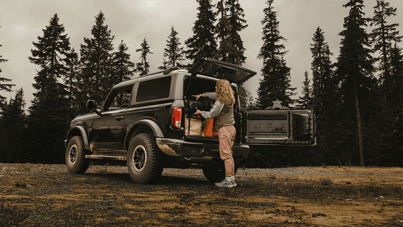 Women putting items in the trunk of a Ford Bronco
