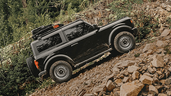 Black Ford Bronco riding on steep uphill