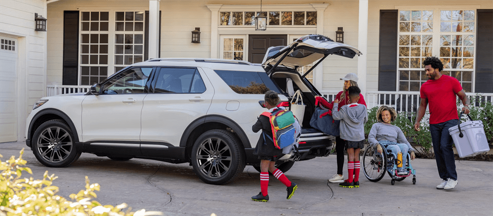 Family loading cargo into Ford Explorer