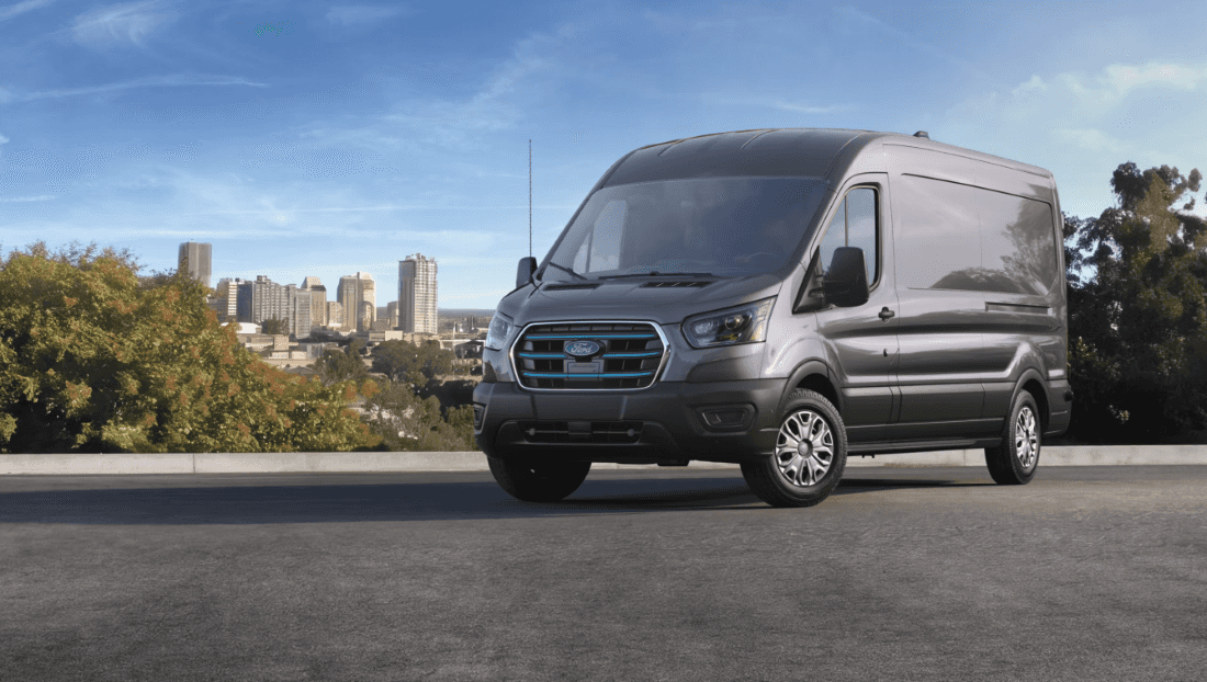 2027 Ford E-Transit parked in front of city skyline