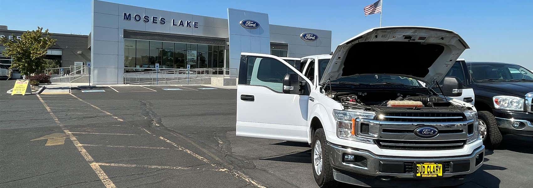 Ford F-150 with doors open parked in front of Bud Clary Ford of Moses Lake