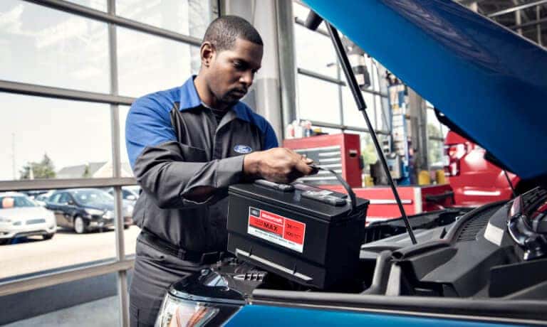 Ford Service technician replacing battery