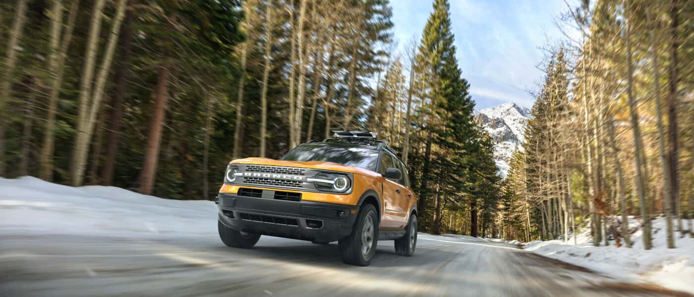 2026 Ford Bronco driving in snowy forest