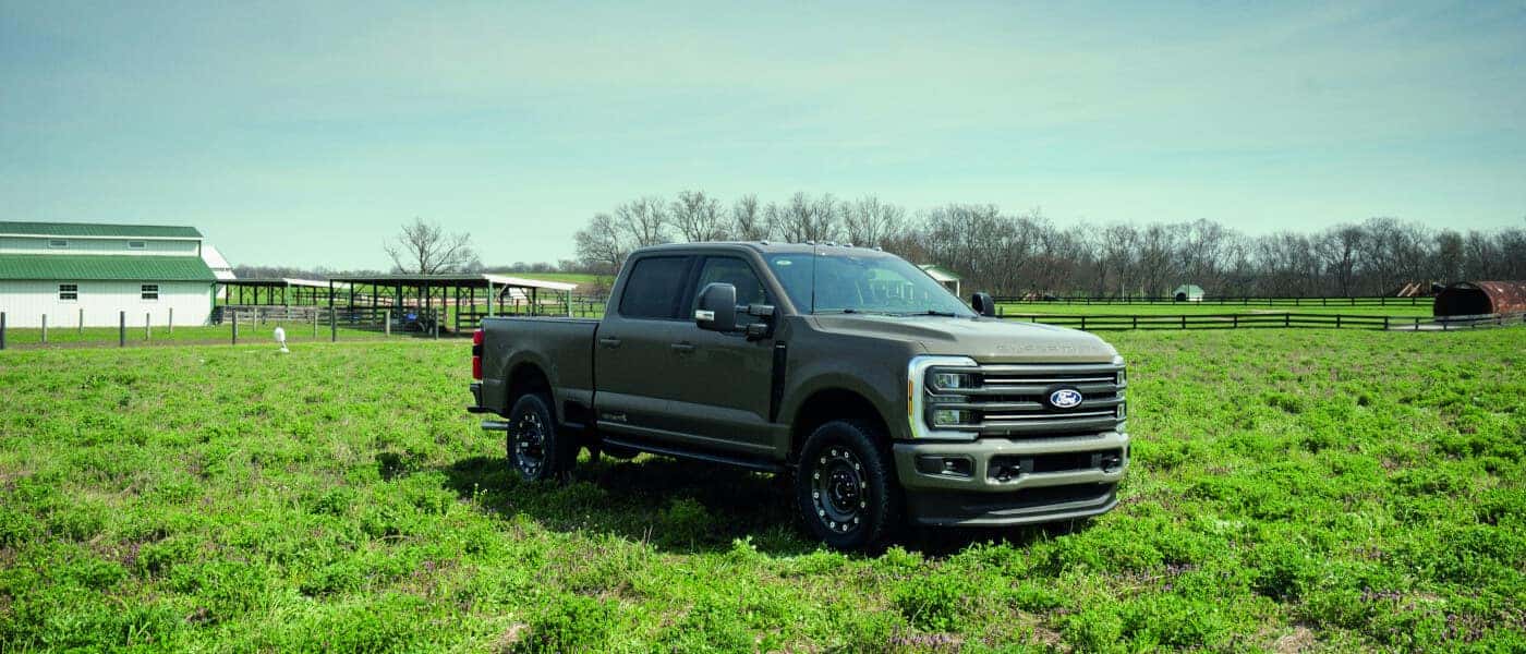 2027 Ford Super Duty parked in a bright green field