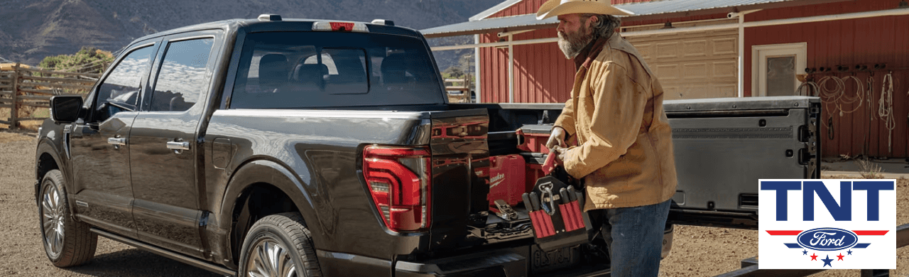 A customer exploring accessories for an F-150 at TNT Ford’s showroom.
