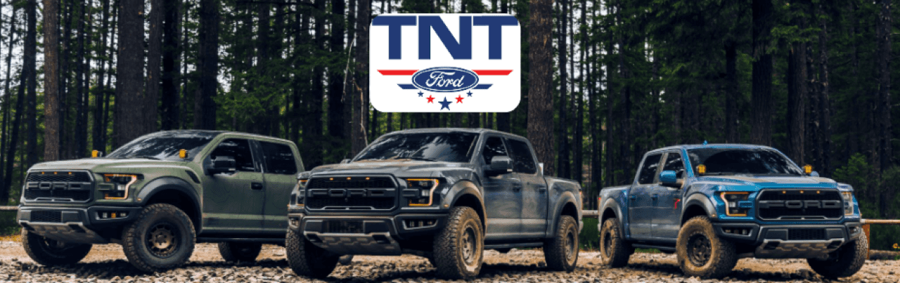 A lineup of Ford F-150 trucks showcasing various models and colors at TNT Ford.