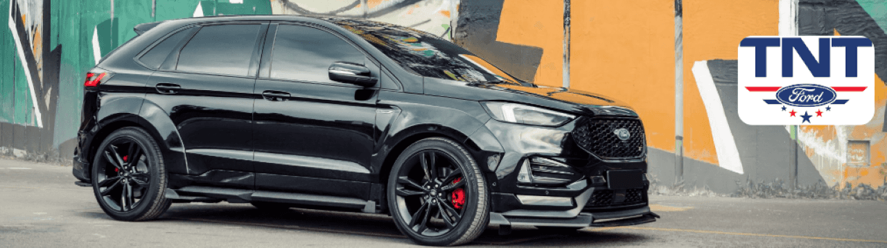 A certified used Ford Edge SUV parked at the TNT Ford dealership in Red Oak, IA