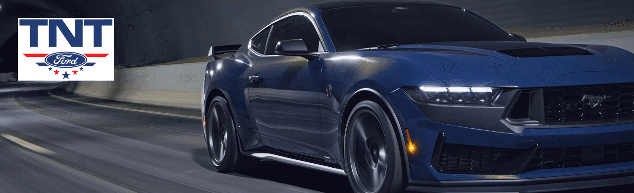 Blue Ford Mustang outside the TNT Ford dealership in Red Oak, IA.