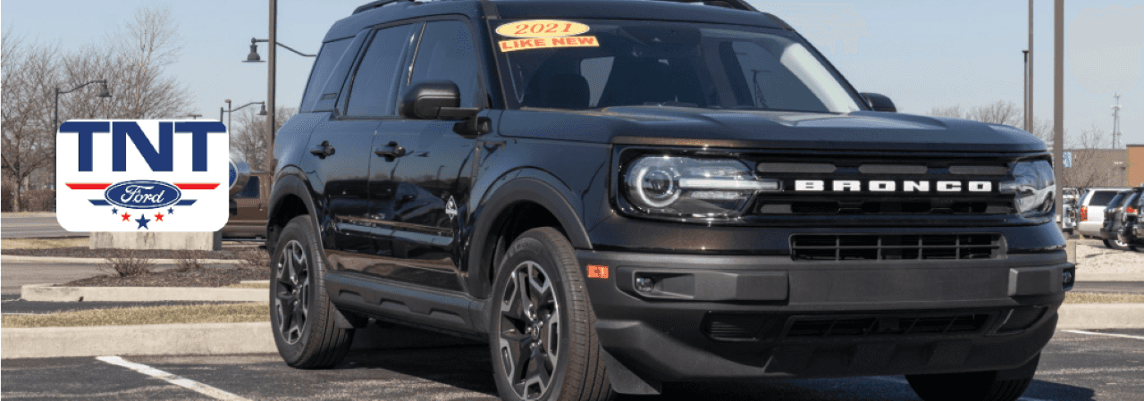 A rugged Ford Bronco parked outside TNT Ford dealership near Red Oak, IA