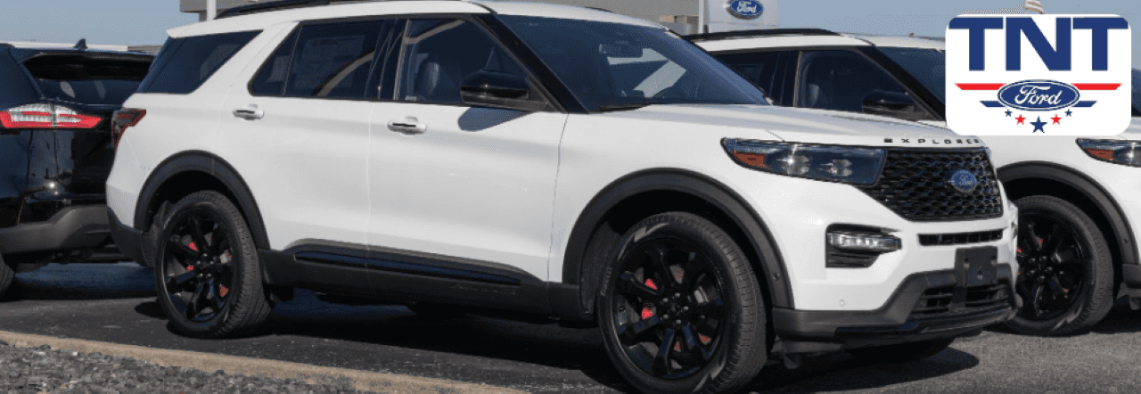 Customer taking delivery of a certified used Ford Explorer outside the TNT Ford dealership