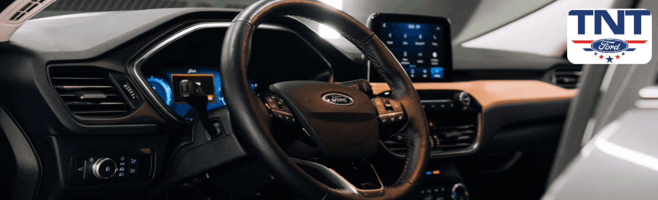 Interior shot of a Ford Maverick dashboard with touchscreen display and fuel-efficient hybrid engine indicator