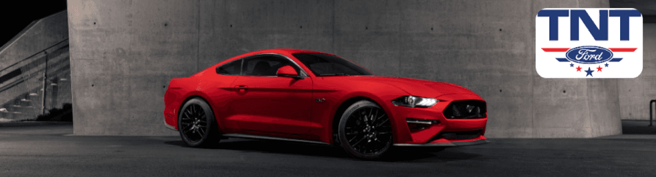2024 Ford Mustang GT in motion on an open road near Montgomery County, Iowa, showcasing its redesigned exterior and performance.