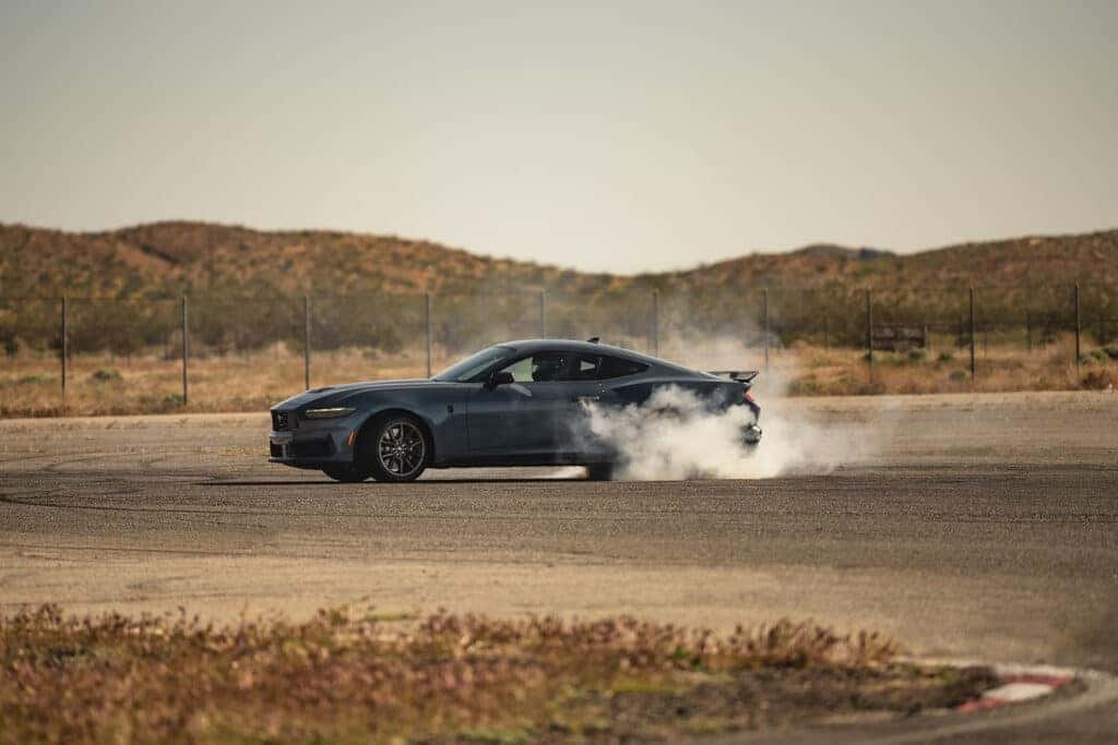 2024 ford mustnag drifting on a road