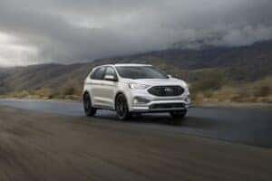 white ford edge driving on the road