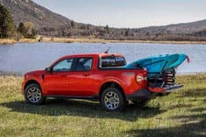 red ford maverick in front of the lake