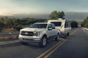 white ford f-150 towing a camper