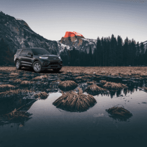 gray Ford Explorer in front of a mountain