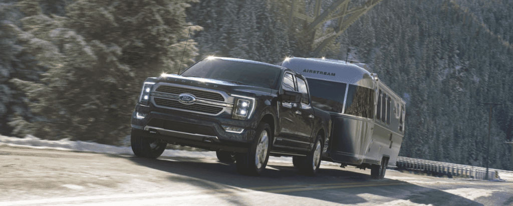 F-150 Hybrid towing trailer through a mountain pass