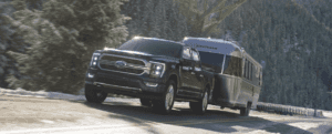 F-150 Hybrid towing trailer through a mountain pass