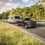 Ford F-150 pulling a trailer on a backcountry road
