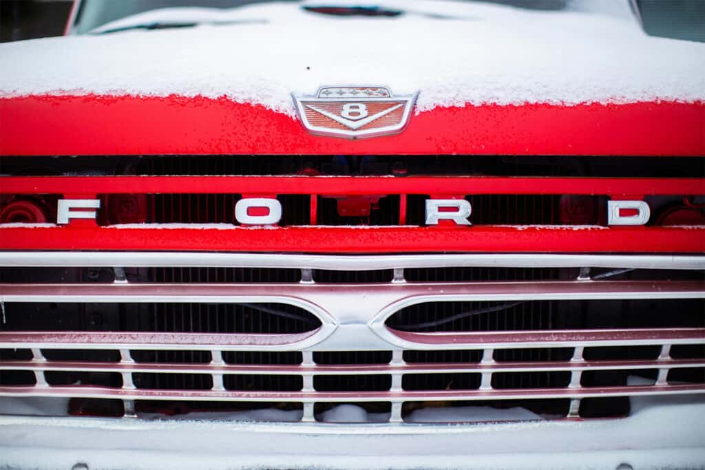 Red retro Ford Grille with snow