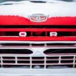 Red retro Ford Grille with snow