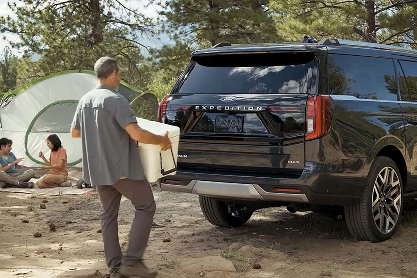 Guy loading a box into a 2026 Ford Expedition