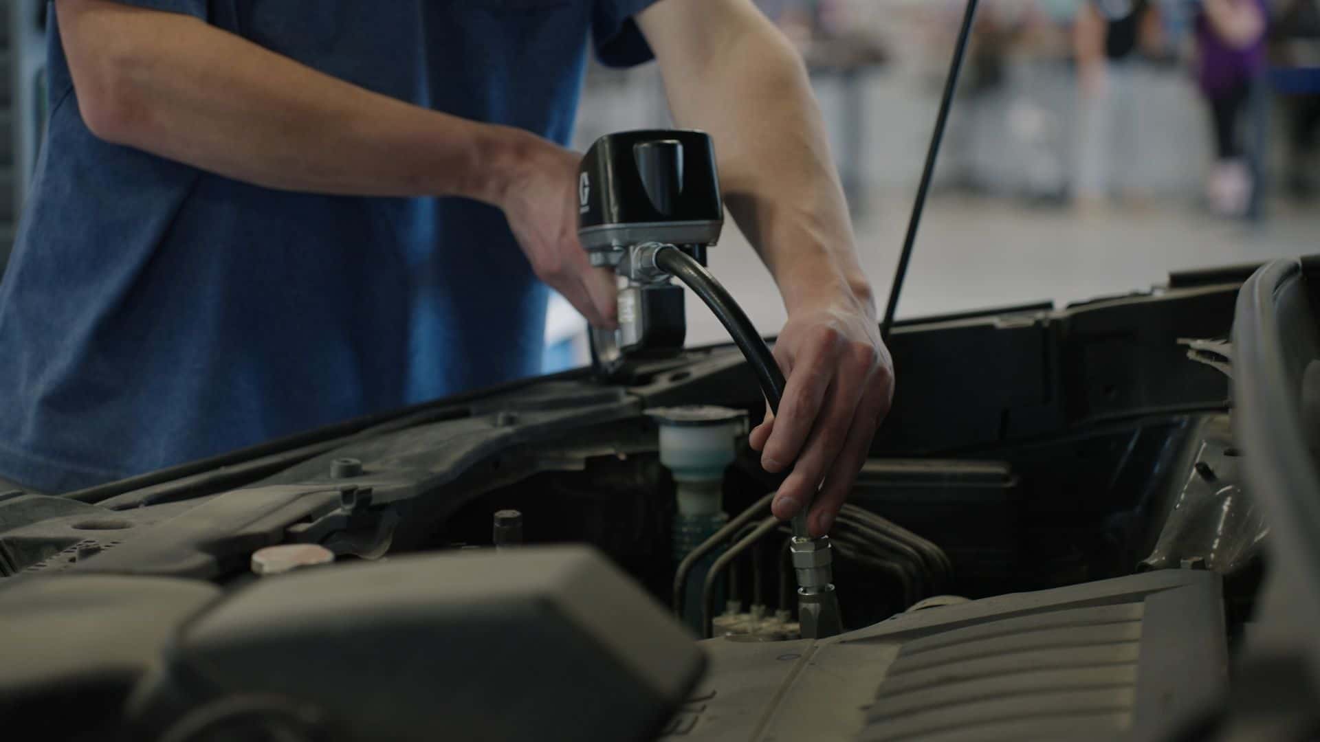 Technican at Kalispell Ford working on a vehicles engine