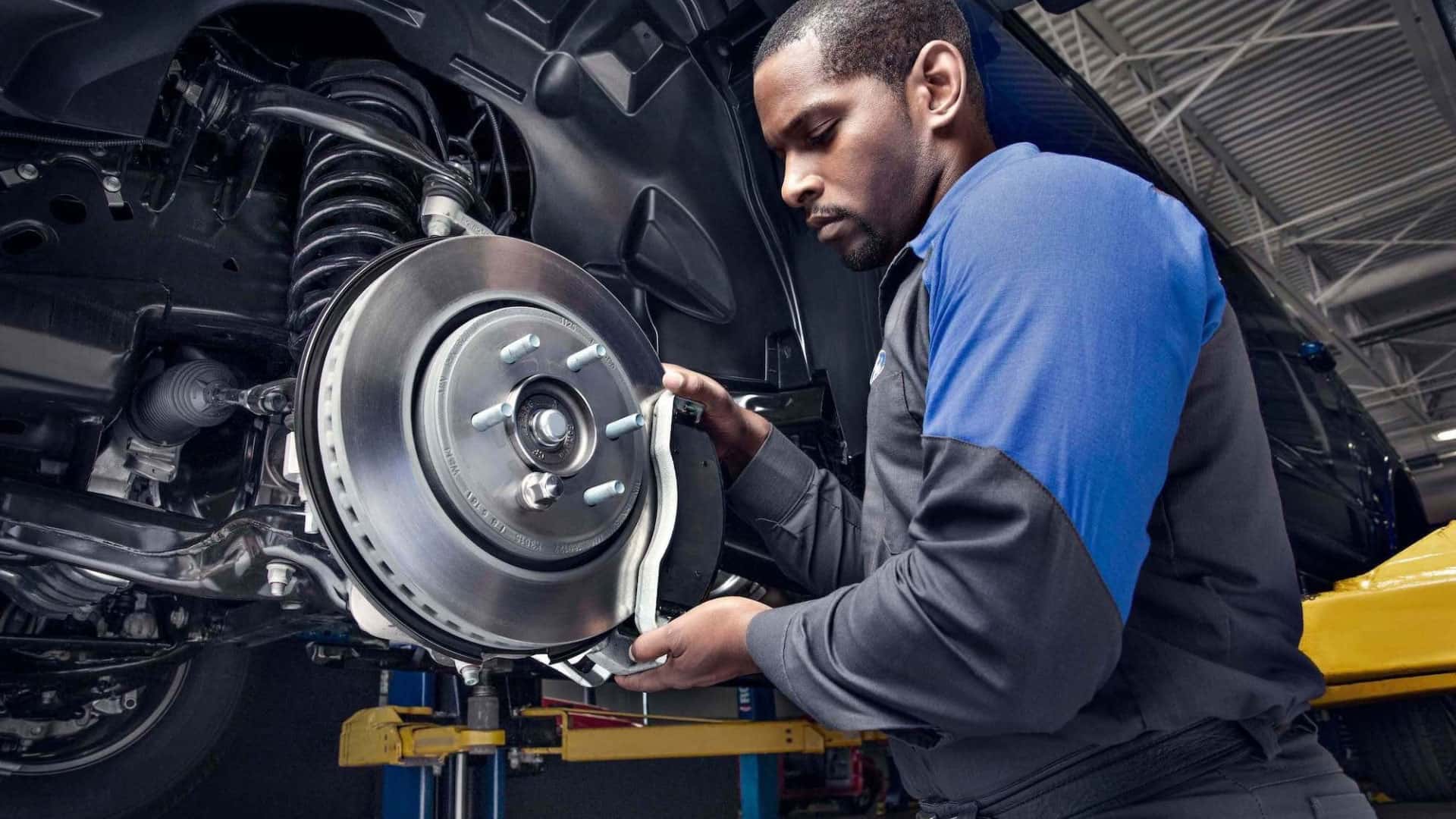 Ford certified technican working on a Ford vehicles brake assembly