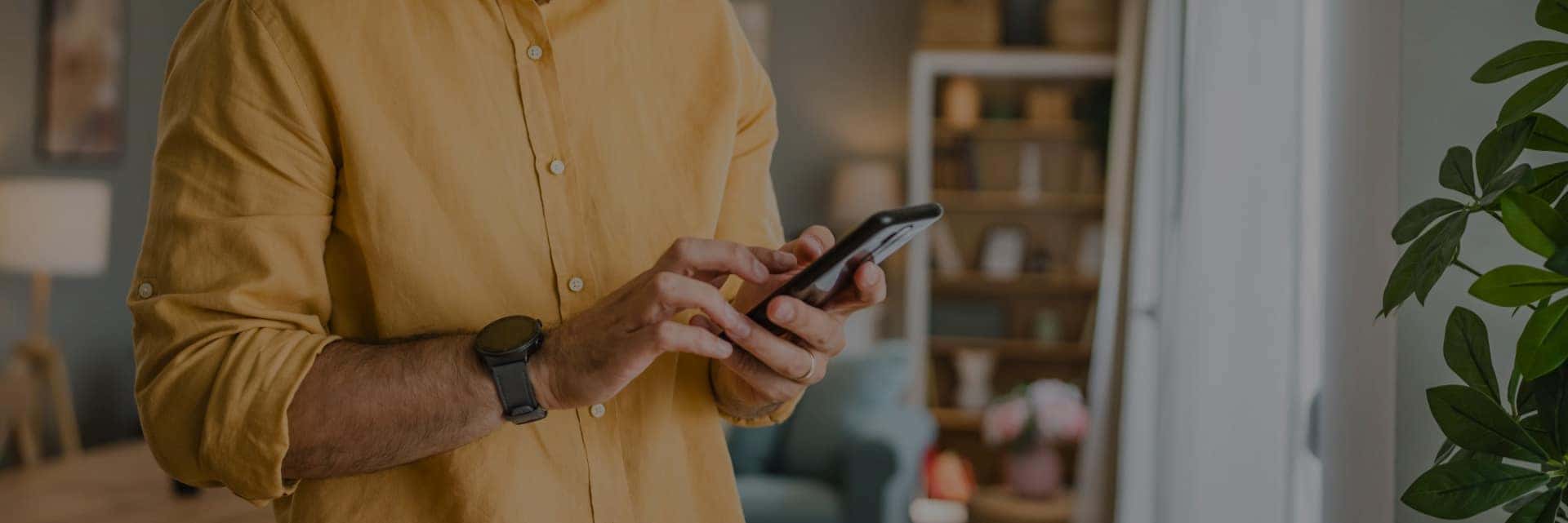 man in yellow shirt on cellphone