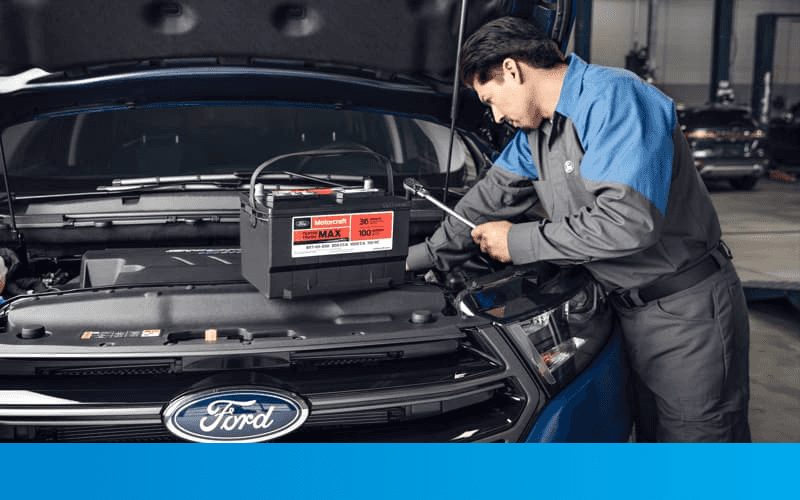 Service Tech is changing battery on a Ford vehicle.