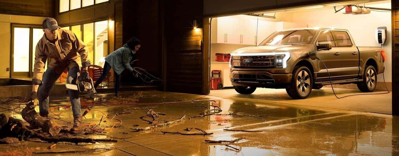 A gray 2024 Ford F-150 Lightning is shown in a garage.