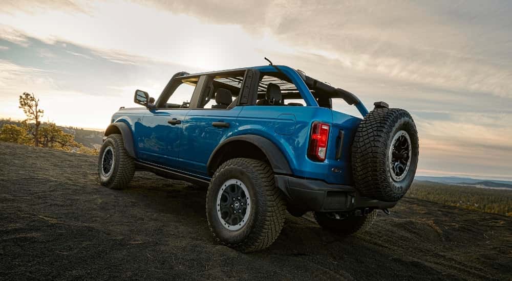 A blue 2025 Ford Bronco parked off-road.