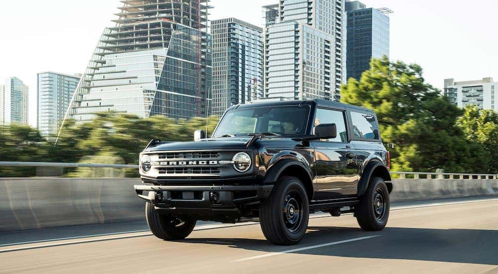 A black 2025 Ford Bronco for sale driving.